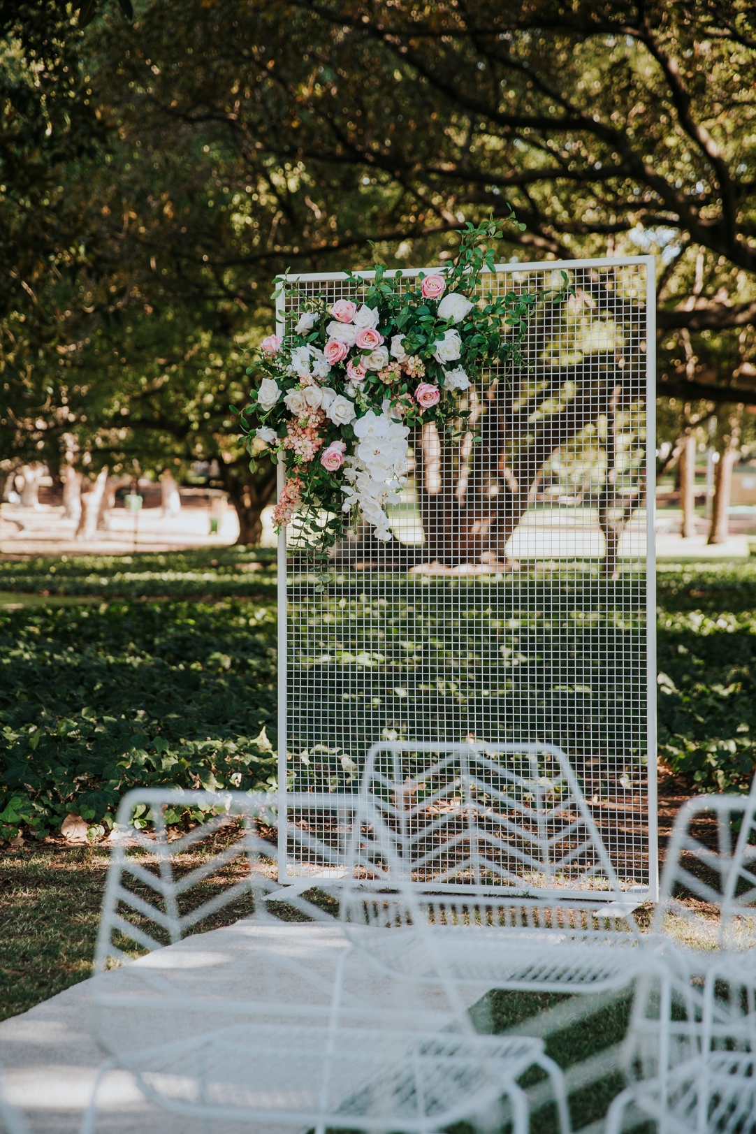 Peacock Chairs with Gold Cushions, White Carpet, Mesh Arbour and Florals